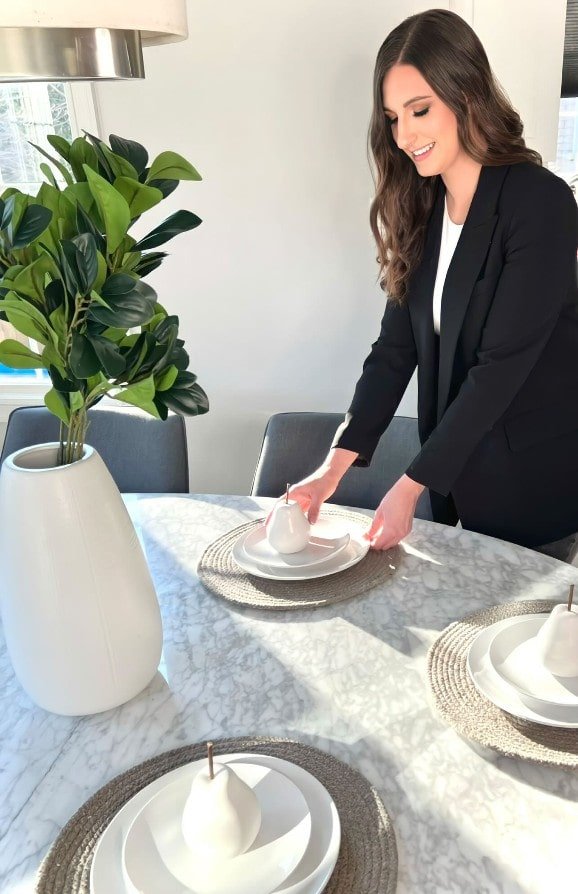 Woman setting up a kitchen table during a home staging session