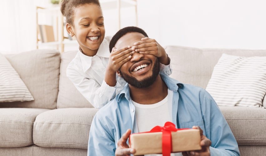 Daughter giving father a present 