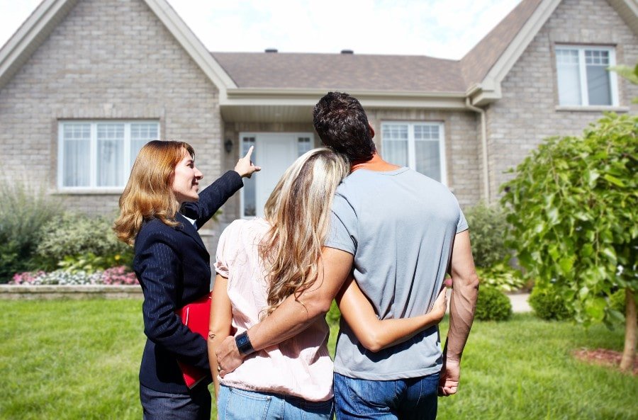 real estate agent showing a couple a home