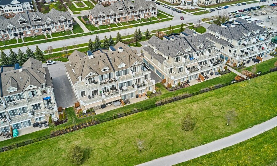 Row of new construction luxury townhomes and walking path in Durham Region